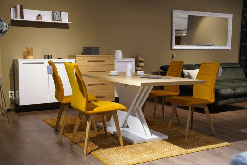 A dining table and four chairs on a showroom floor