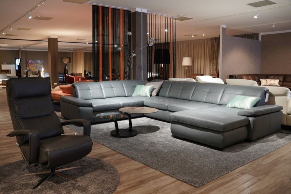The video window shows the showroom floor as your colleague walks toward the sofa